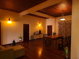a living room with a couch and a table at The Loris Manor in Nuwara Eliya