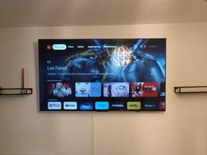 a flat screen tv hanging on a wall at Résidence Carnot in Alfortville