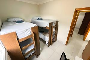 um pequeno quarto com 2 beliches e um espelho em M101 - Apartamento Completo Para Até 6 Hóspedes em Patos de Minas