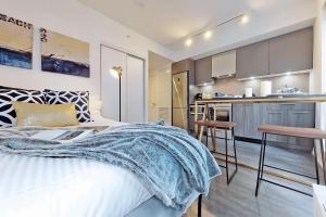 a bedroom with a large bed and a kitchen at Cozy Suite in Heart of Downtown Toronto J7 in Toronto