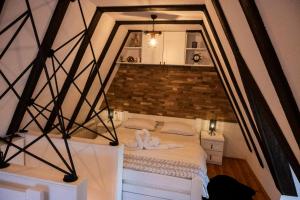 a bed in a room with a brick wall at Kalina Lux House in Bijelo Polje