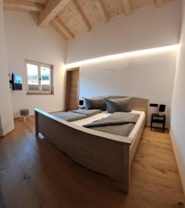 a bedroom with a large bed in a room at Chalet Groissenbach in Reit im Winkl