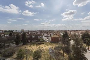 a view of a city with houses and trees at Apartamento EL MIRADOR, recepción 24 h, piscina, wifi y parking interior in Bormujos +5 photos
