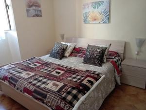 a bedroom with a bed with a quilt on it at Casa Vacanze SOFIA in Bolsena