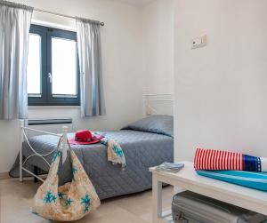 a bedroom with a bed and a table and a desk at Stefano's Villa in Cisternino +34 photos