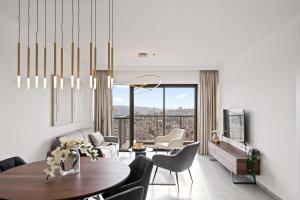 a living room with a table and chairs at Savion View City Center Jerusalem in Jerusalem