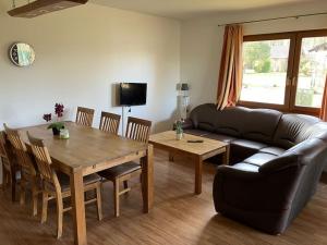 a living room with a table and a couch at Ferienhaus Lena am Silbersee in Frielendorf