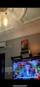 a flat screen tv sitting in a living room at RAMS ENG ROME appartement meublé in Douala