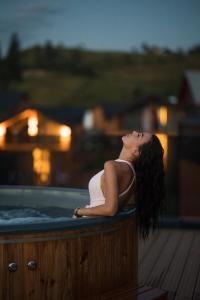 a woman is sitting in a jacuzzi tub at Phoenix Relax Park in Bukovel