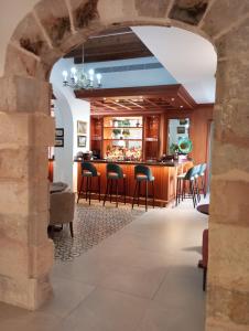 a bar in a restaurant with a stone archway at Finca Sa Bastida Luxury Retreat & Spa Adults Only - Over 14 in Sant Joan