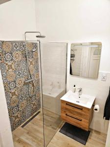 a bathroom with a shower and a sink at Justinrent 2 in Legnica +3 photos