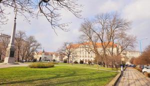 a large building with a monument in the middle of a park at Justinrent 2 in Legnica