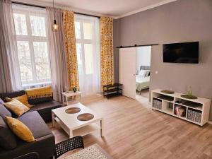 a living room with a couch and a table at Justinrent 2 in Legnica
