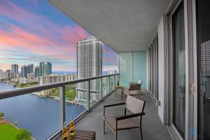 a balcony with chairs and a view of the city at Infinite View and Balcony with Pool, Gym, Near Beach in Hallandale Beach