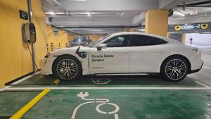 a white car is parked in a parking garage at Hotel Vema in Visoko