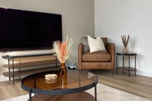 ウィックにあるBraeview, Contemporary Luxury NC500 Holiday Home - Sleeps 5のリビングルーム(ソファ、ガラステーブル付)