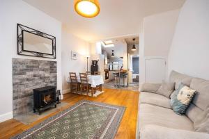 a living room with a couch and a fireplace at Super 2-Bed House 5 min to Harcourt Tram Stop in Dublin