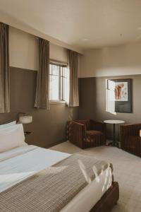 Ένα ή περισσότερα κρεβάτια σε δωμάτιο στο The Atlee Suites