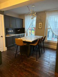 a kitchen with a table and chairs in a room at Patrick Street Townhouse in Cork