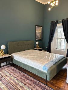 a bedroom with a bed with two tables and a window at Patrick Street Townhouse in Cork