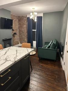 a kitchen and living room with a couch and a table at Patrick Street Townhouse in Cork