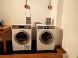 two washing machines next to each other in a room at Nice Turin 26 - Porta Nuova - Metro Marconi in Turin