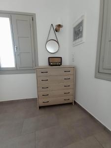 a room with a dresser with a lamp on it at Seascape, apartment with sea view 1 in Áno Meriá
