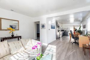 a living room with a white couch and a kitchen at Newly Renovated 2BR 1BA Near San Jose Downtown up to 20 percent off in San Jose