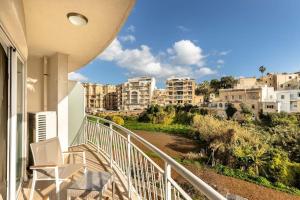a balcony with a view of a city at Cozy 3BD Seaside Apartment! WiFi and Great Location! in Tal-Għoqod
