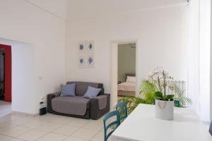 a living room with a chair and a couch at San Liborio Suites in Naples