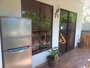 a stainless steel refrigerator in a kitchen with a patio at HOTEL EL VIAJERO in La Libertad