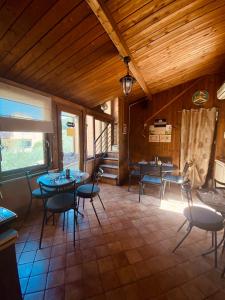 a restaurant with tables and chairs in a room at Aurelia Garden Gold B&B in Rome