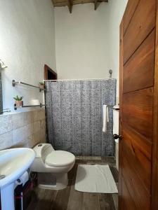 La salle de bains est pourvue de toilettes, d'un lavabo et d'une douche. dans l'établissement Residencial Paraiso by Alex, à Bayahibe