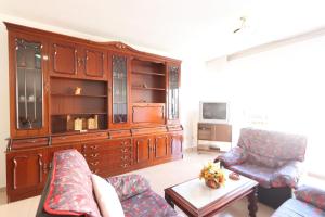 a living room with a large wooden entertainment center at Apartamento CASA VETONA in Béjar