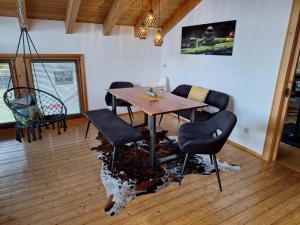 a dining room with a wooden table and chairs at Lechapart Wagner in Reutte