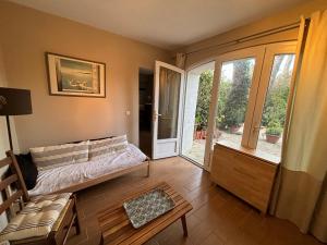 a bedroom with a bed and a sliding glass door at Studio 28 m2 minimum 3 nuits in Marseille