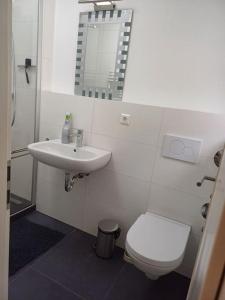 a bathroom with a white toilet and a sink at wie zu Hause in Ludwigsburg