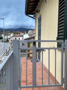 einen Balkon eines Gebäudes mit einem Tor und einer Straße in der Unterkunft Ma maison jolie in Incisa in Valdarno