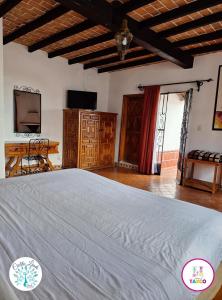 a bedroom with a large bed in a room at Hotel Cielito Lindo, Taxco in Taxco de Alarcón
