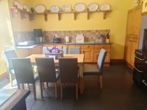 a dining room with a table and chairs in a kitchen at Duddon Villa in Millom +9 photos