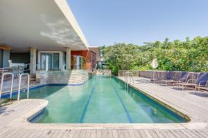 a swimming pool with a deck and a house at 10 Dash Apartment, Dunkirk in Sheffield Beach