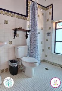 a bathroom with a toilet and a shower at Hotel Cielito Lindo, Taxco in Taxco de Alarcón