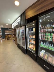 a grocery store aisle with two refrigerators at Florida Mall & Suites in Limeira