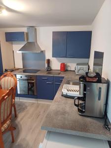 a kitchen with blue cabinets and a counter top at wie zu Hause in Ludwigsburg