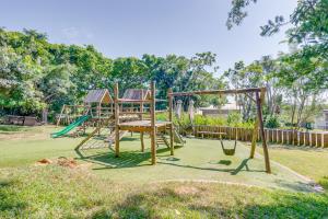 a playground with a swing set in a yard at 10 Dash Apartment, Dunkirk in Sheffield Beach