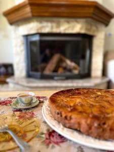 a cake on a table in front of a fireplace at Petrameli in Karpenisi +34 photos
