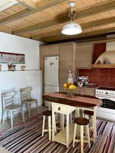 a kitchen with a table and chairs and a refrigerator at Petrameli in Karpenisi