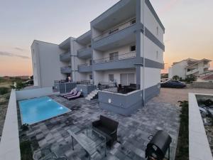 an image of a house with a swimming pool at Apartments Pool Villa Maria, Novalja in Novalja