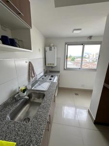 a small kitchen with a sink and a window at Departamento céntrico in Salta