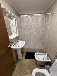 a bathroom with a sink and a toilet at Departamento céntrico in Salta
